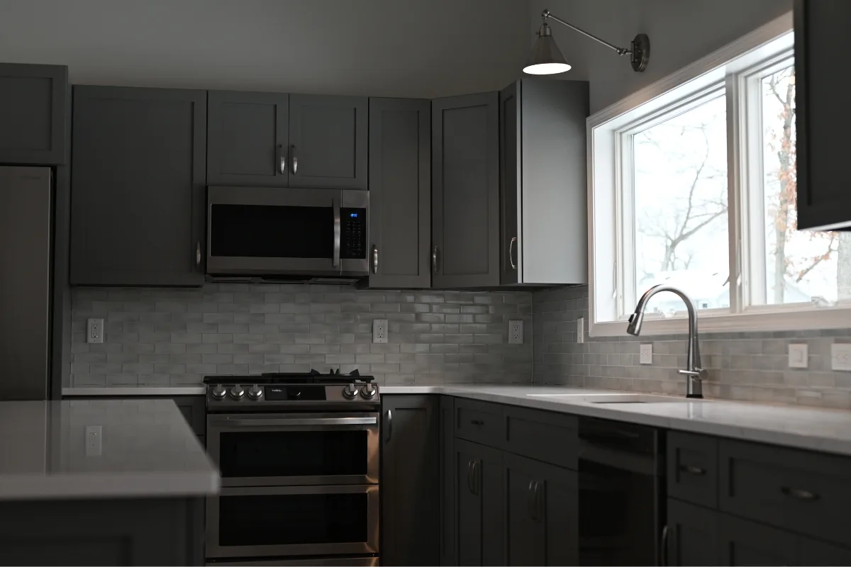 Wolf Lake kitchen with gray Superior Series cabinets and quartz countertops